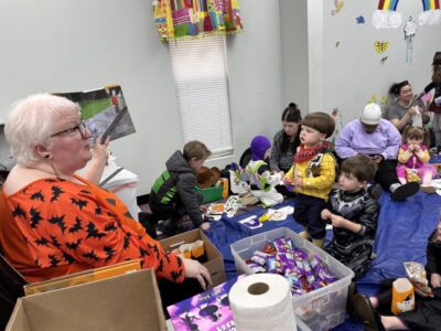 Children trick-or-treat through Millbrook Library during spooky story time