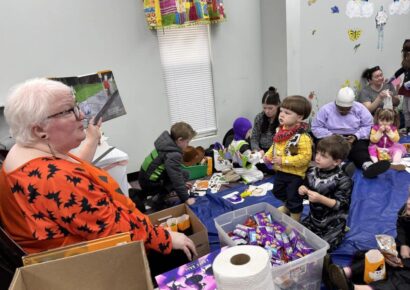 Children trick-or-treat through Millbrook Library during spooky story time