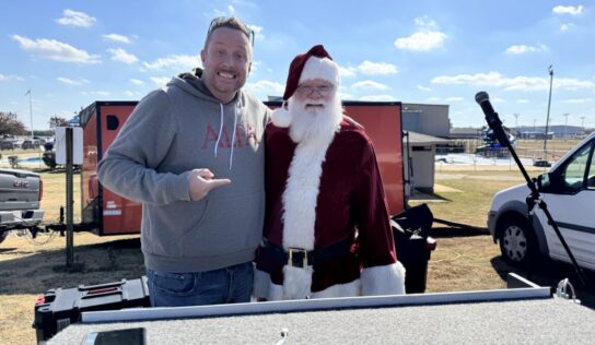Hundreds gather to welcome skydiving Santa and Grinch
